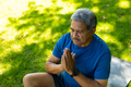 High angle view of biracial senior man with eyes closed meditating while sitting on mat over grass - PhotoDune Item for Sale