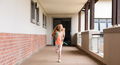 Full length of smiling caucasian elementary schoolgirl with backpack running in school corridor - PhotoDune Item for Sale