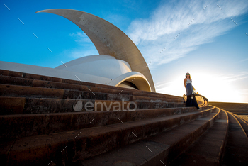 5: Auditorio de Tenerife in Santa Cruz de Tenerife with woman walking. This auditorium was designed by famous architect Santiago Calatrava
