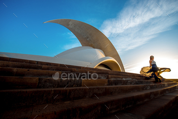 5: Auditorio de Tenerife in Santa Cruz de Tenerife with woman walking. This auditorium was designed by famous architect Santiago Calatrava