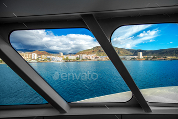  05, 2016: View on  Los Cristianos resort from the ferry floating near the island coast on Tenerife in Spain