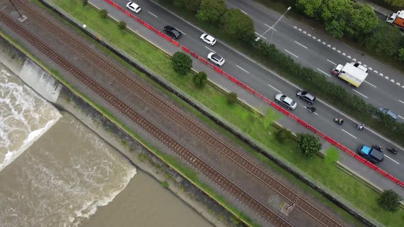 Highway in the middle of the city next to railway and a river channel