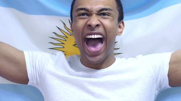 Argentinian Fan Celebrates Holding the Flag of Argentina