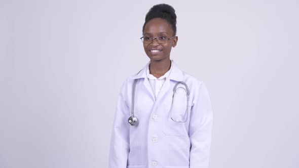 Young Happy African Woman Doctor Thinking