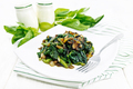 Spinach fried with onions in plate on light board - PhotoDune Item for Sale
