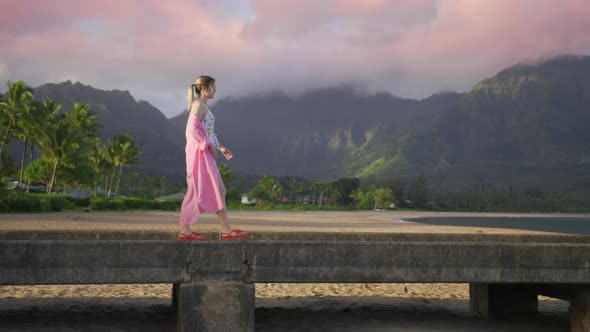 Woman with Breathtaking Hawaii Landscape Background Pink Sunrise Clods on Peak