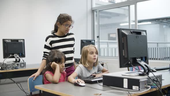 Multiethnic Girls Looking at Computer Monitor During Class