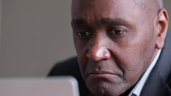 Closeup Focused Male Wrinkled Face Looking at Laptop Screen African Mature Business Man Uses