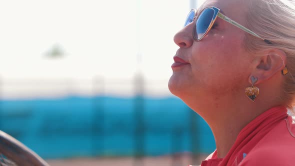 Female Tennis Coach Talking to Her Students