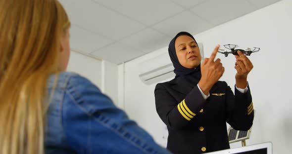 Female pilot about model drone to kid 