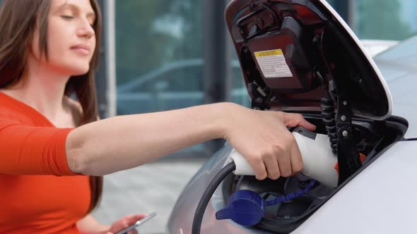 Girl Pulls Out the Charger of Her Electric Car