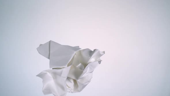 Crushed paper flying in the air, Slow Motion