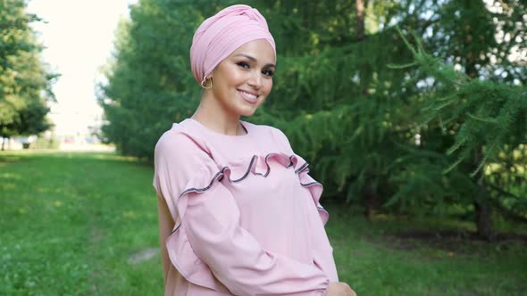 Smiling Model in Fashionable Purple Dress and Hijab Poses