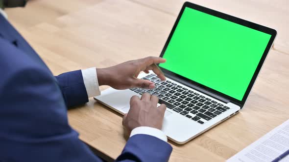 African Man Using Laptop with Chroma Screen