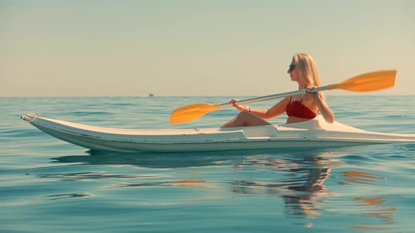 Girl In Kayak Summer Trip. Woman Exploring Calm Sea By Canoe On Holiday Vacation Weekend.