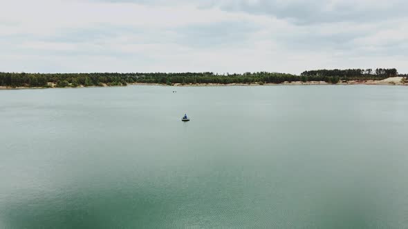 Lonely Man in Boat in the Middle of the Lake Lake Summer Natural Landscape with Pine Tree Forest