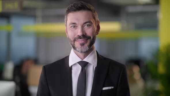 Portrait of Adult Business Man Boss Standing in Office Smiling Looking at Camera While Employees are