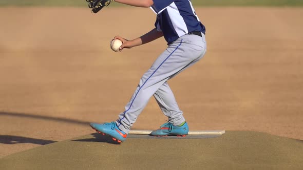 The pitcher in a boys little league baseball game.