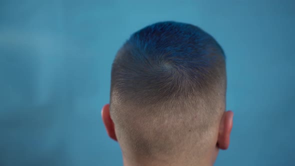 A Young Man Is Dyed His Hair Blue. A Alternative People Is Painted with Temporary Hair Dye From a
