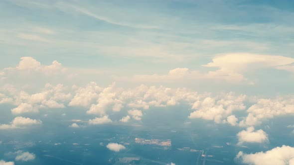 Aerial view above clouds. View from airplane window. Travelling by plane from Johor Bahru to Kuala L