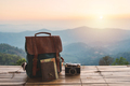 Travel backpack and retro camera with landscape view of mountain at sunrise - PhotoDune Item for Sale