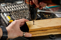 Man hand drilling into wood self-tapping screw twisted into place - PhotoDune Item for Sale