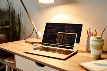 cozy home office workplace lit by lamplight, copy space
