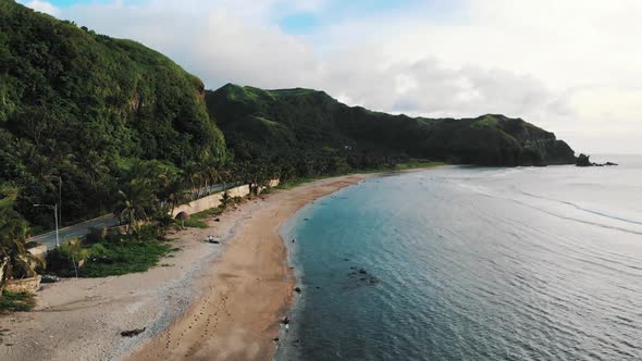 Rising above a long beach shore in Batanes, Philippines