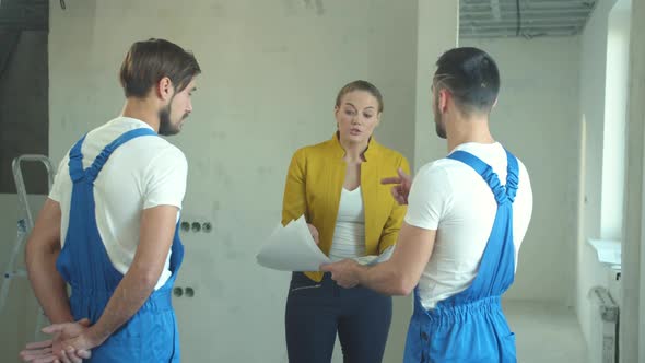 Woman Shows a Drawing and Argues with Builders