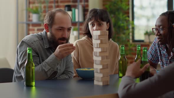 Positive People Having Fun with Jenga Board Game in Living Room