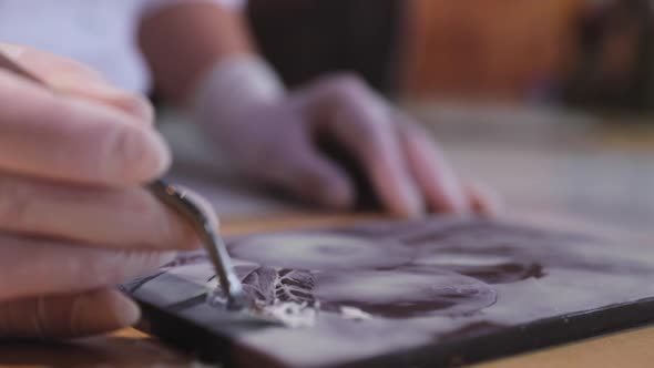 Chocolate Art. Closeup Of Cutting Picture On Handmade Chocolate