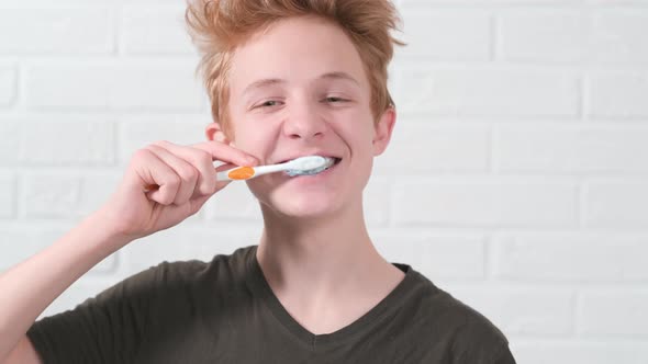 Portrait Smiling Red Haired Teen Boy with Toothbrush