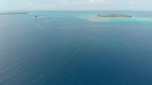 Aerial: flying over desert island tropical beach caribbean sea turquoise water c