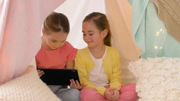 Little Girls with Tablet Pc in Kids Tent at Home