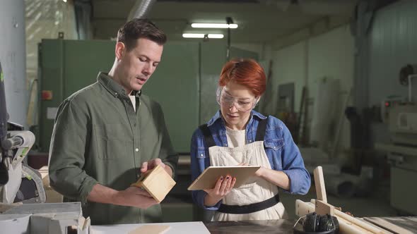 Customer and Carpenter Have Talk in Workshop Discussing Sharing Ideas What to Make