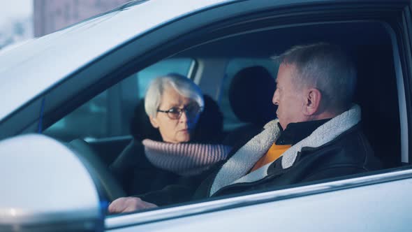 Elderly Couple Looking at Each Other in Shock Realising There Is Police Behind Their Car