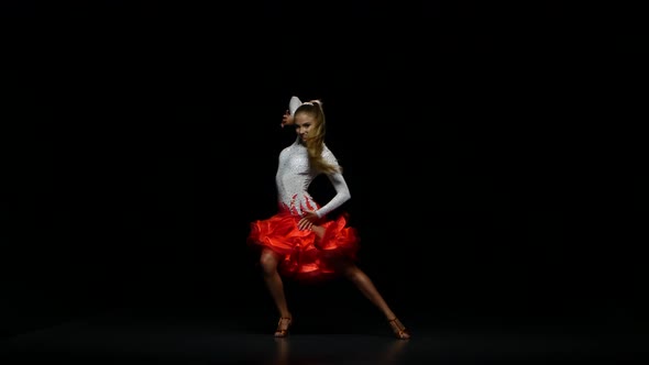 Woman Dancing Cha-cha-cha in a Studio on a Dark Background