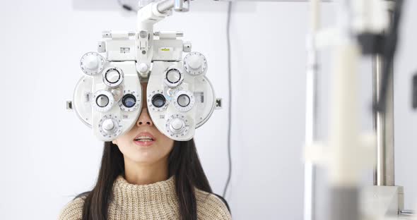 Young Woman doing eye test in clinic