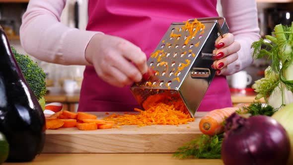 Woman Grating Carrot