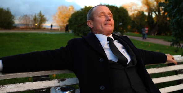 Senior Businessman Relaxing In City Park alt