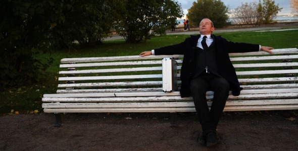 Senior Businessman Relaxing in Park Dolly Shot