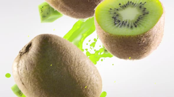 Kiwi with Slices Falling on White Background