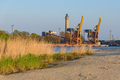 Port cranes and a lighthouse in Swinoujscie - PhotoDune Item for Sale