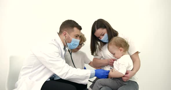 Mother with Kids on Checkup at Pediatrician Office