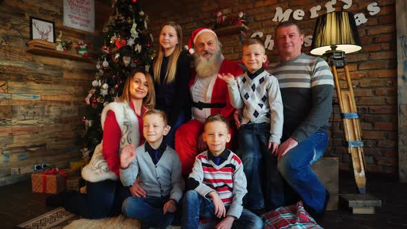 Happy Family Gathered To Exchange New Years Gifts and Make Wishes for Santa Claus in Room Decorated