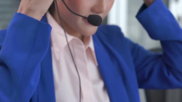 Businesswoman Wearing Headset Working Actively in Office