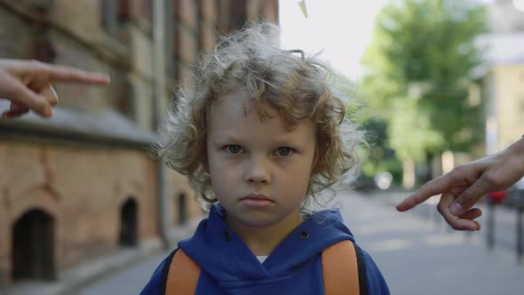 Adults Bullying Schoolboy with a Backpack on the Street Near School