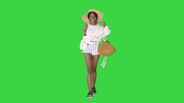 Summer in the City Beautiful African American Woman Wearing Fashionable Hat Walking on a Green