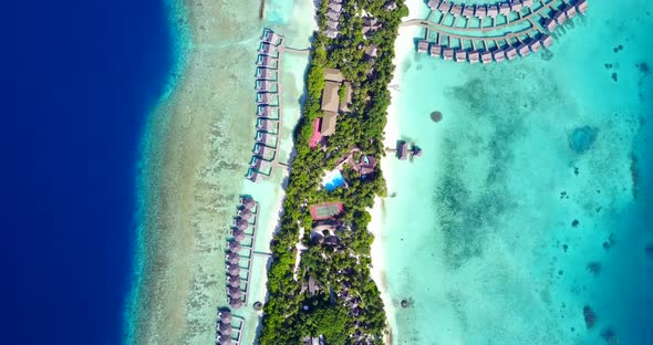 Wide aerial tourism shot of a summer white paradise sand beach and aqua turquoise water background i