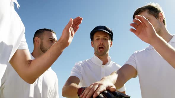 Cricket players forming a hand stack during cricket match